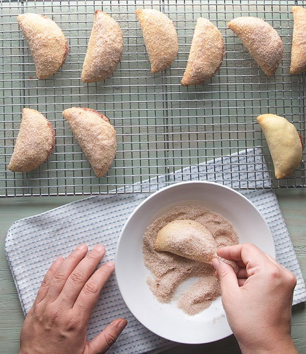 Peaches-and-Cream-Empanadas_dusting-empanadas-in-sugar-and-cinamon_